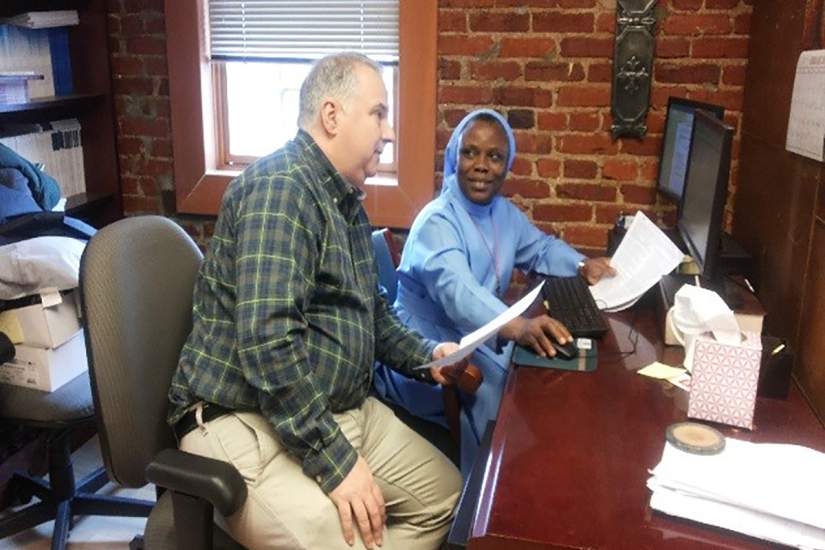 Dr. Jon Wiggins and Sr. Florence writing a report at CARA.