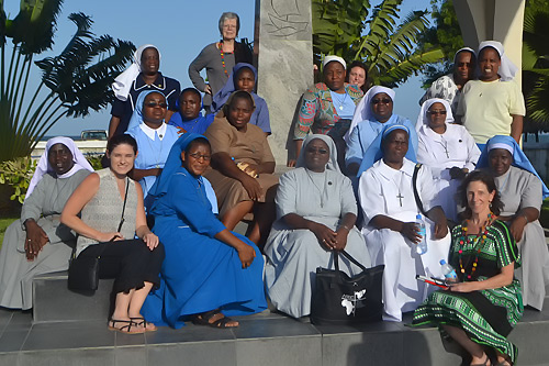 ASEC board members Brighid Blake (standing, top) and Terri Peters (bottom, right) pose for a group photo with ASEC staff.