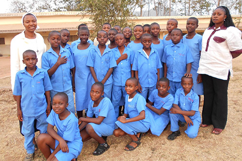 Sr. Yvette Sam (left) with a handful of Students of St. Marys’ Catholic Comprehensive College, Ndop.