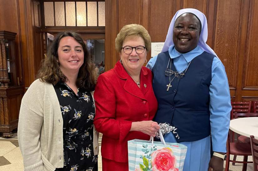 Executive Director Sr. Draru Mary Cecilia and Senior Program Manager Rosemary Shaver congratulate Sr. Carol Jean Vale on her retirement at the 