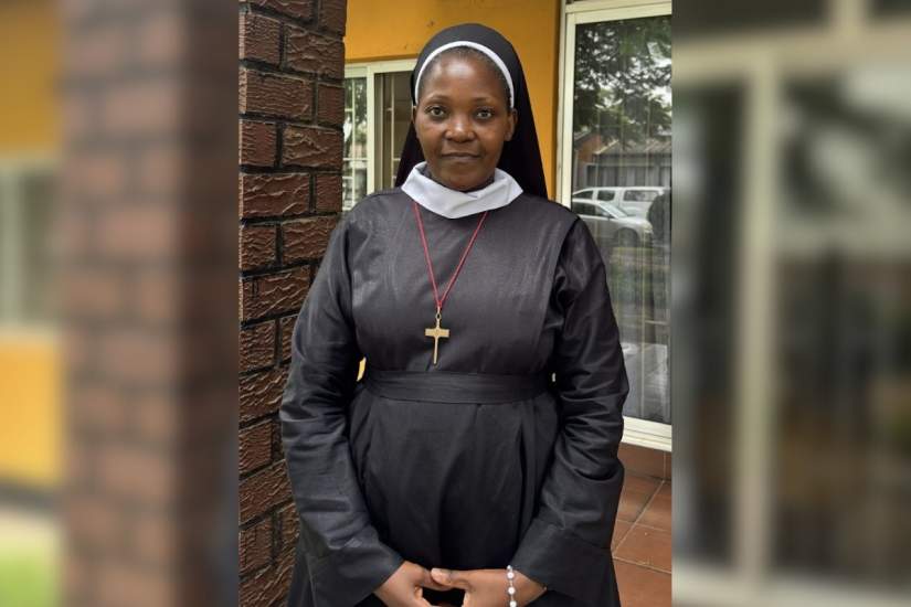 Sr. Bertha Chisanga, CPS, stands outside the Zambia Association of Sisterhoods (ZAS), where she leads initiatives that expand educational access and support for vulnerable girls in her community.