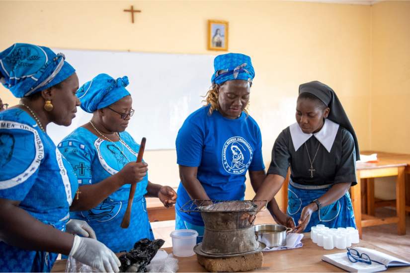 Women trained by Sr. Teresa gather together to demonstrate the skills they have learned in Soap Making and other vocations. Here, Sr. Teresa showcases how to make petroleum jelly.