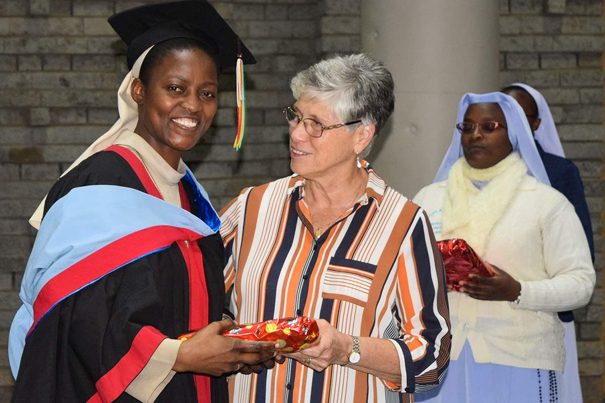 Sr. Mary Persico talking with an ASEC-sponsored CUEA graduate in Nairobi, Kenya (October, 2019).