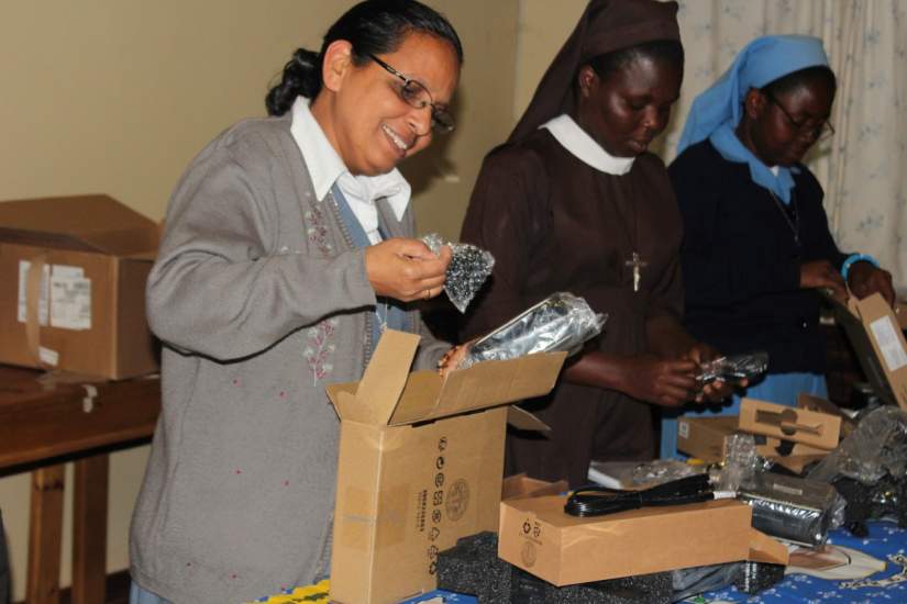 Sr. Elsamma is all smiles as she unpacks her new laptop provided by ASEC's generous funder, Conrad N. Hilton Foundation.