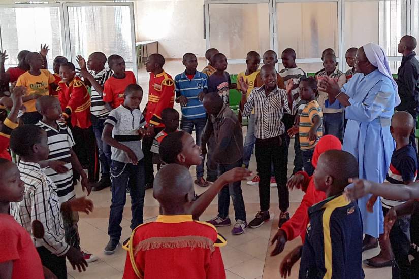 Sr. Draru with street boys at Kwetu Home of Peace, a rehab
center in Nairobi, Kenya where ASEC alumnae serve (Oct., 2018).