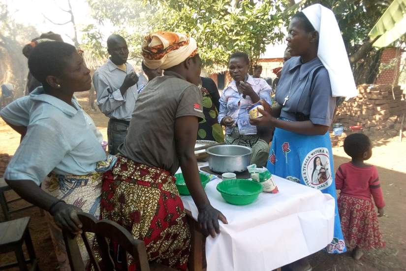 Sisters offer training support groups to the Bembeke community of individuals diagnosed HIV positive. Here a sister demonstrates food preparation using local resources for healthy living.