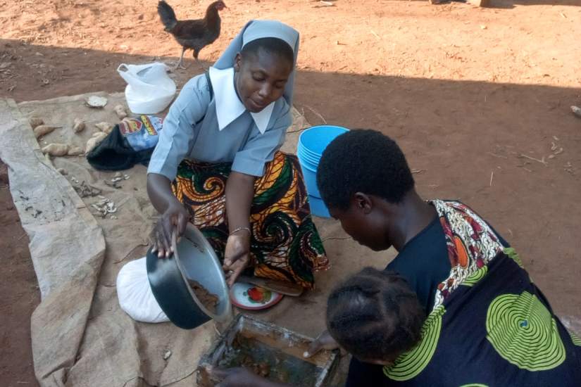 A Teresian sister demonstrating how to prepare fresh juice.