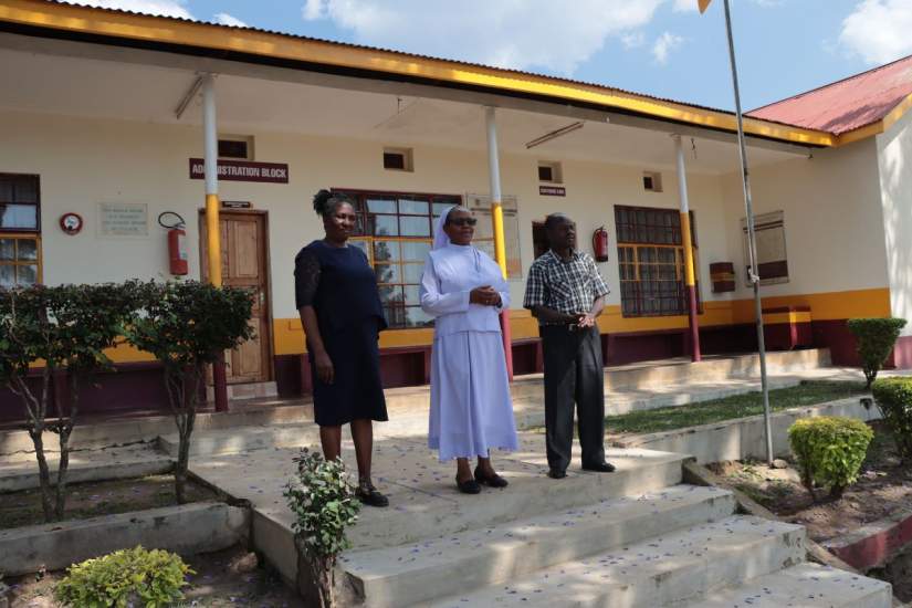 Sr. Gertrude (center) stands with staff outside her ministry site in Kenya.