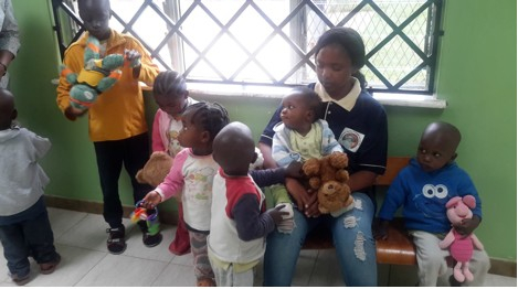 A caretaker with the children at Cottolengo Centre in Nairobi, Kenya.