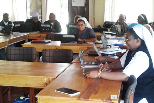 Malawian sisters in the SLDI program practicing computer skills in class.