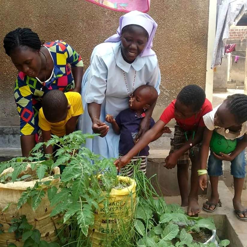 Sr. Mary grows food from broken buckets and sacks to feed those in need due