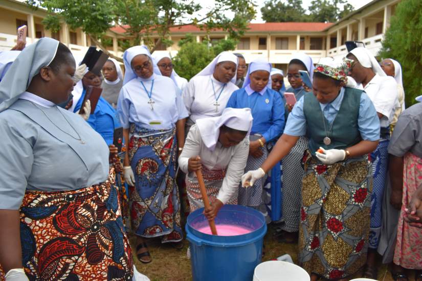 ASEC alumnae learn to make liquid soap at a workshop in Tanzania in January of 2023.