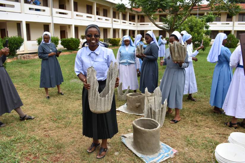 ASEC sisters make flower pots from cement, water and old towels.