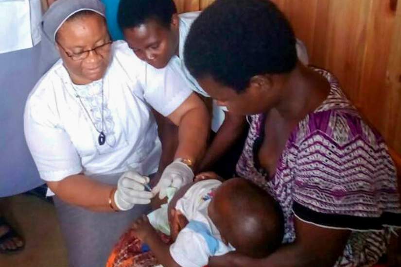 In Malawi, SLDI alumna Sr. Grace Akpan sees over 200 malaria patients a month during the busiest season. Here, she's treating a baby girl named Remi for malaria.