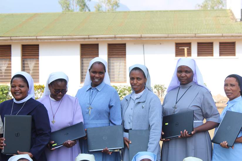 Sr. Constansia (2nd from left) looks at her laptop with a smile during the SLDI Finance Track II Workshop that took place in Tanzania from August 12 - September 9, 2017.