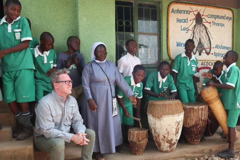 After the conference, ASEC staff and partners visited students and ASEC alumnae at Kikyusa Primary & Secondary schools in Kikyusa, Uganda. In this photo Jim Sullivan, Dean of Continuing and Professional Studies at Marywood University in Scranton, Pennsylvania, US enjoys a performance by the students.