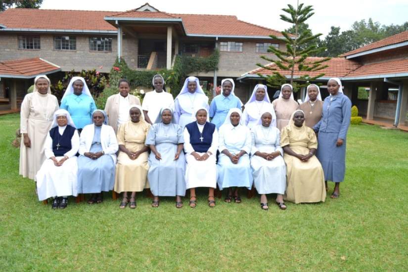 Students post for a group photo. Standing, L-R: Kanjiru Mwamba, Lydiah Apili, Adeodata Ahimbisibwe, Lilian Ogutu, Susan Ngugi, Delfina Luma, Miriam Obiekwe, Rebecca Makungu, Maryrose Koech, Catherine Ndereba  Sitting, L-R: Marie Therese Fernando, Angelina Mulani, Elizabeth Kivungi, Petronilla Kyomugisha, Margaret Wangeci, Mary Annet Namara, Jane Watenga, Anisia Kitaka