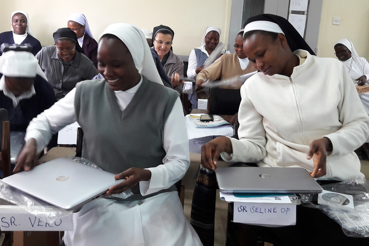 Sr. Veronica and Sr. Seline checking on their new laptops during the SLDI Finance I Workshop in Kenya.