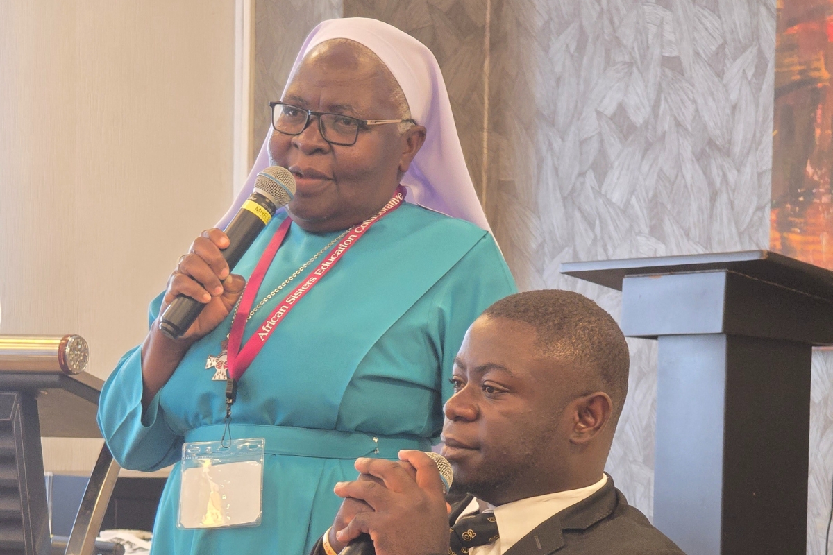 Sr. Regina Nakyeyune Lawrence, GSS (left), speaks alongside Augustine Kitonsa (right), a resident of Mapeera Bakateyamba Center.
