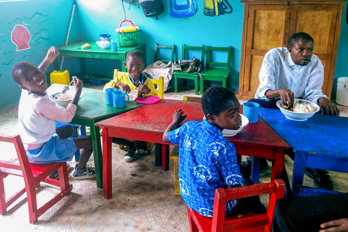 Children at St. Elizabeth Day Center for Children & Young Adults with Disabilities share a meal and welcome ASEC staff (June, 2018).