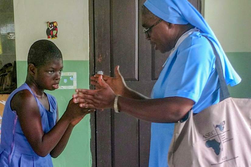 ASEC's Regional Director of West Africa, Sr. Francisca Damoah, SIJ, plays with one of the children at St. Elizabeth's during a staff site visit (June, 2018).
