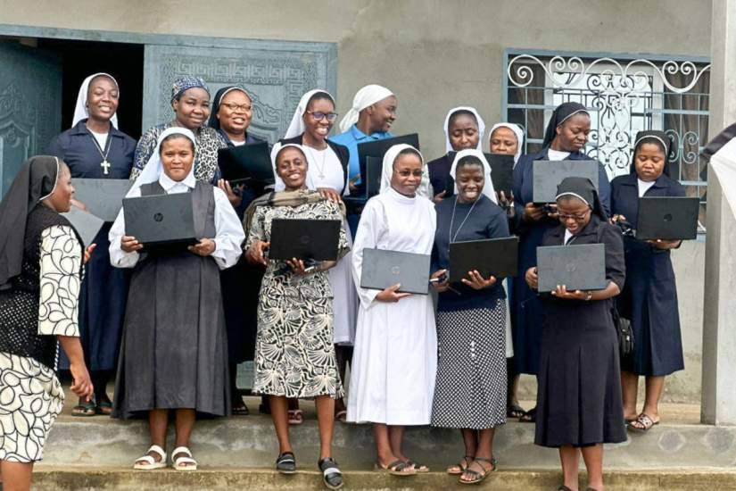 SLDI participants receive new laptops at the construction
site of future SLDI classrooms in Cameroon.