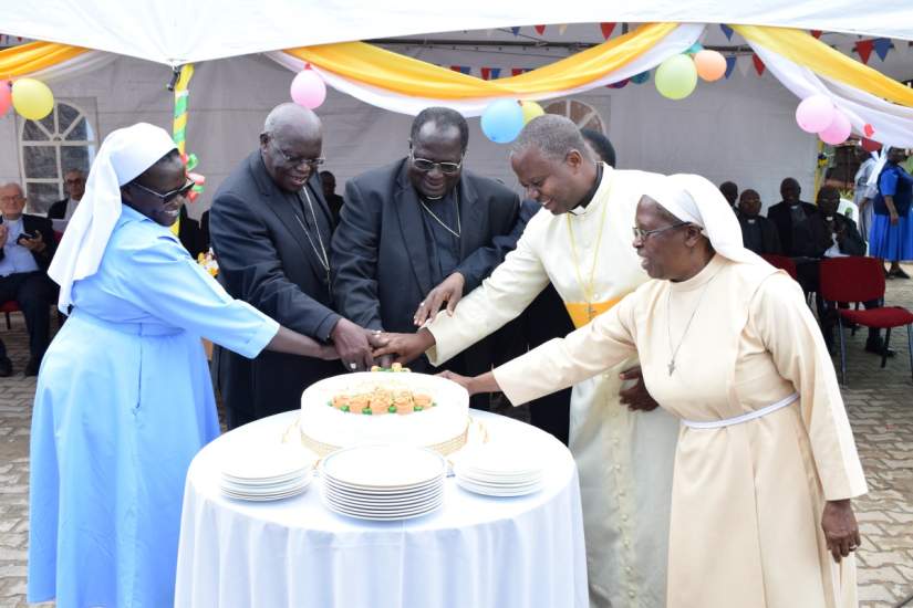 Archbishops John B Odama & Emmanuel Obbo and religious cut cake at ARU Golden Jubilee launch (November 8, 2017).