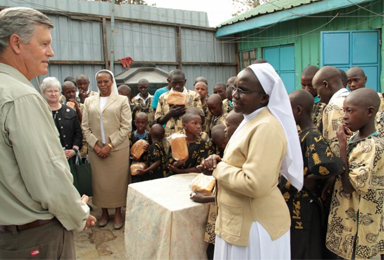 Steve Hilton, grandson of hotelier Conrad N. Hilton, talks with Sister Anisia Kitaka, a member of the Little Sisters of St. Francis of Assisi, during a 2012 visit to St. Francis Rehabilitation Center for Street Children in Nairobi, Kenya. Steve Hilton will soon retire as president and CEO of the foundation his grandfather established 70 years ago to support Catholic sisters all over the world. (CNS photo/courtesy Conrad N. Hilton Foundation)