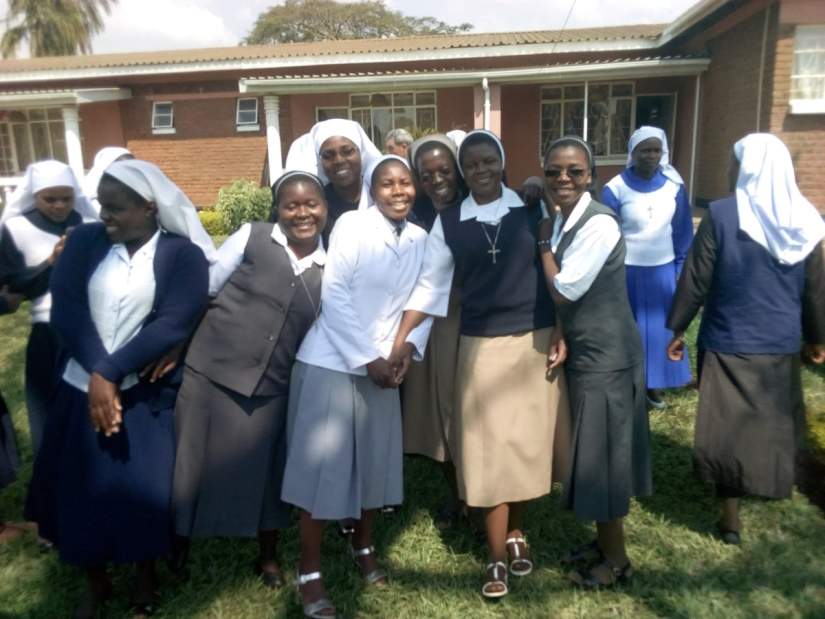 Sr. Teresa (center, in white) poses with some of the workshop participants.