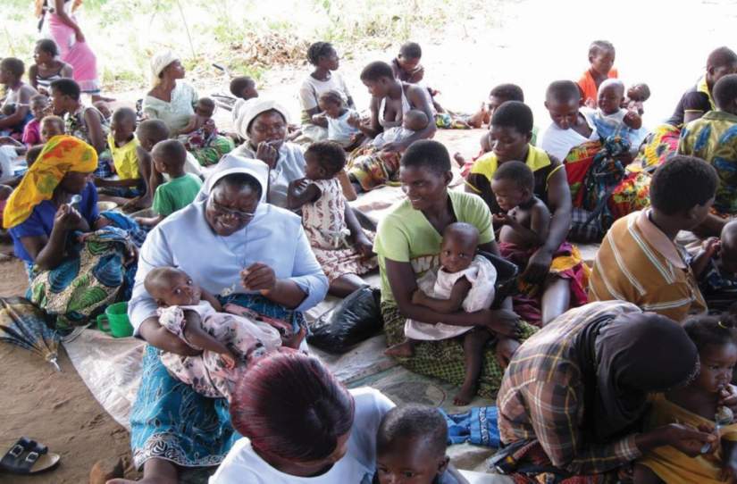 Sr. Hellen Matchado is improving nutrition and food security in Malawi for pregnant women. Here, she's seen feeding a malnourished child and demonstrating positive parenting to new mothers.
