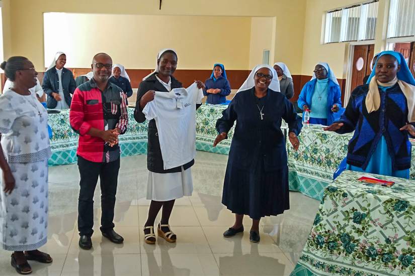 During the HESA Reflective Learning workshop in Malawi, Sr. Evarista (holding shirt) received recognition for maintaining the rank of top student at the Catholic University of Malawi for five consecutive semesters.