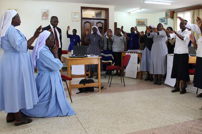 Sr Irene and participants of Finance II pray for ASEC's new Executive Director, Sr. Draru Mary Cecilia, LSMIG.