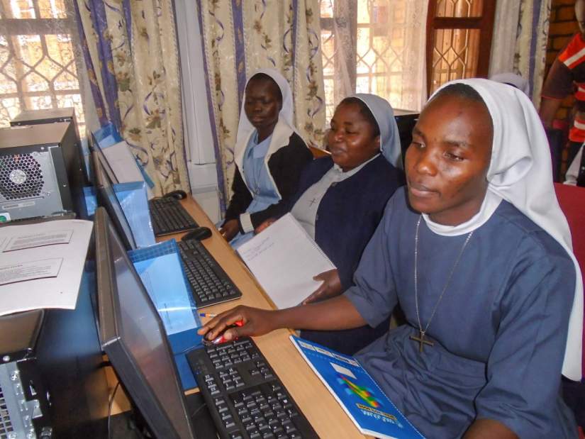 Sr. Faustina (right) learning how to use the computer in SLDI's Basic Technology workshop (May, 2016).