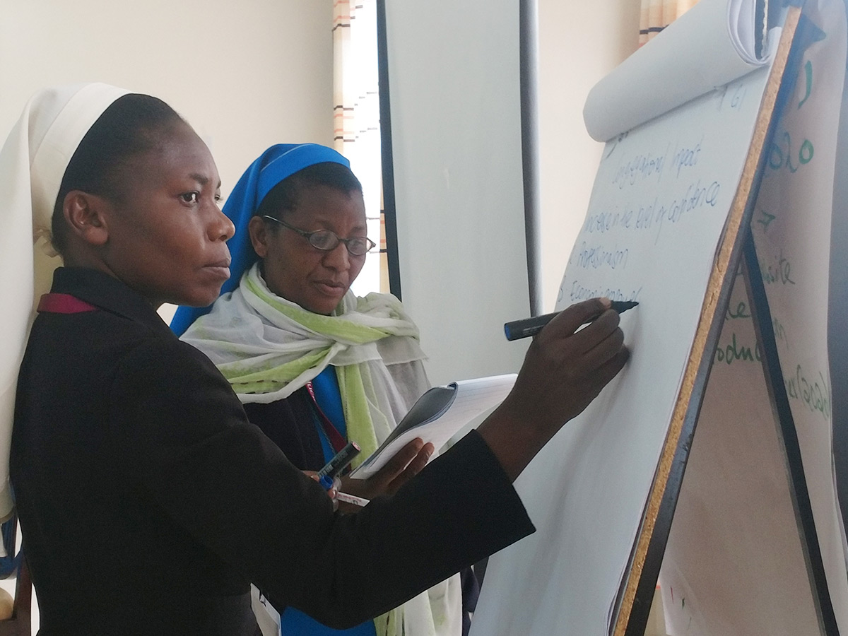 ASEC Programs Coordinators Sr. Teresa Mulenga, Malawi and Sr. Juliana Chibaula Zulu, Zambia brainstorming together at the Partners Workshop.