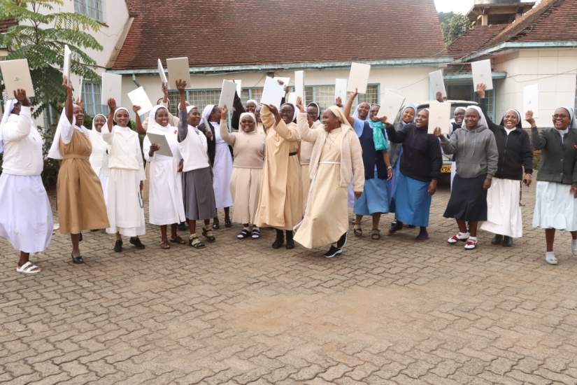Sisters celebrate receiving laptops as part of their SLDI Basic Technology Workshop