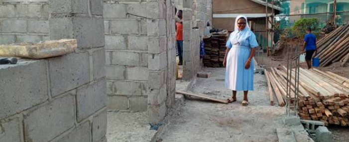 Sr. Furaha at the on-going construction of storied block of a school in Kazo