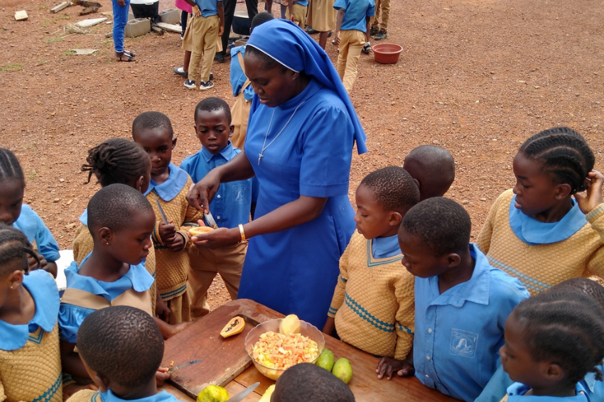ASEC sister Sr. Honorine with pupils during cooking practicals in Cameroon