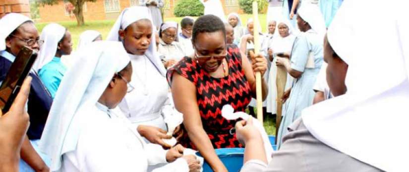 Alumni learning how to mix liquid soap at one of their workshops in 2016 at National Seminary Ggaba.