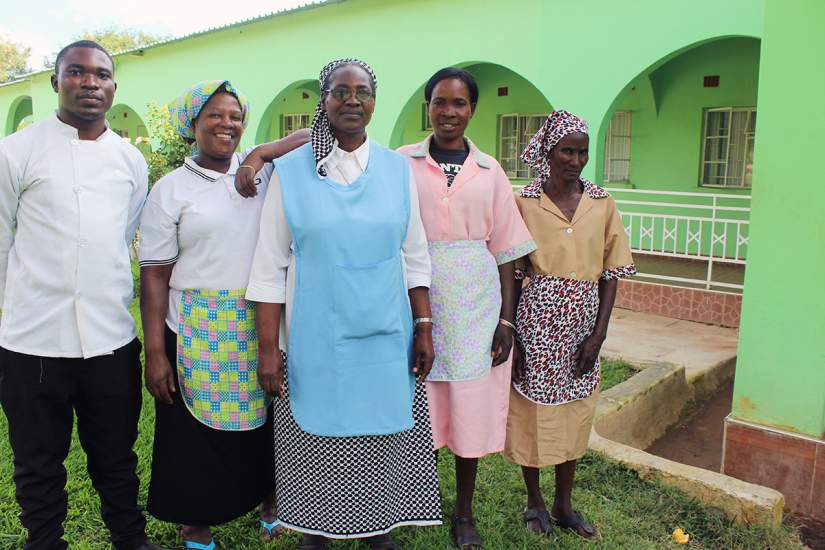 Sr Priscilla Mwanza, center, poses for a photo with the staff at Mt. Zion retreat centre. She's currently an SLDI participant studying Finance.