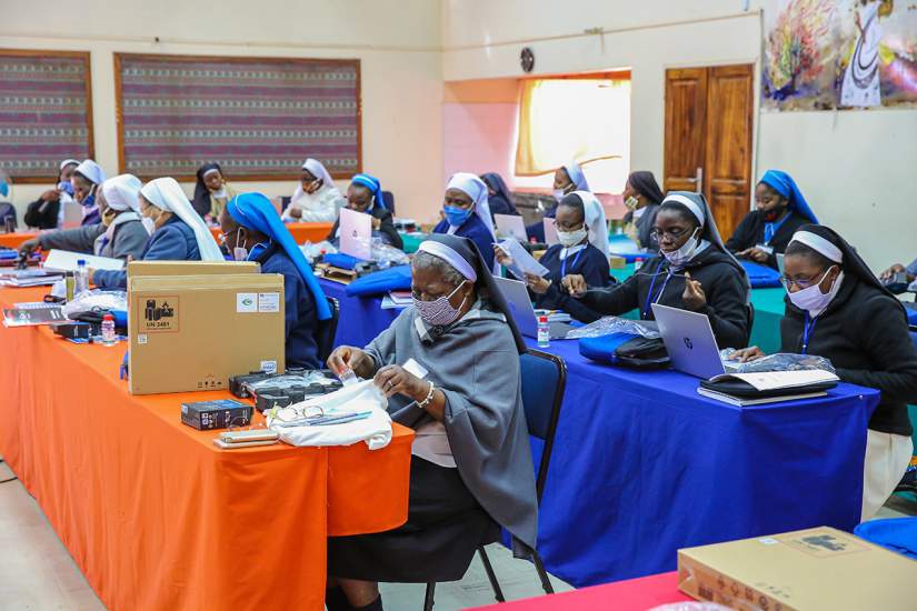 COVID-19 could not spoil this day for SLDI participants in Zambia; sisters eagerly explore their new laptops.