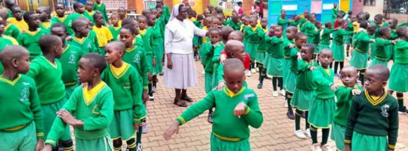 Sr. Josephine Bwekembe with Canossa St. Joseph Nursery and Primary School Lweza pupils
