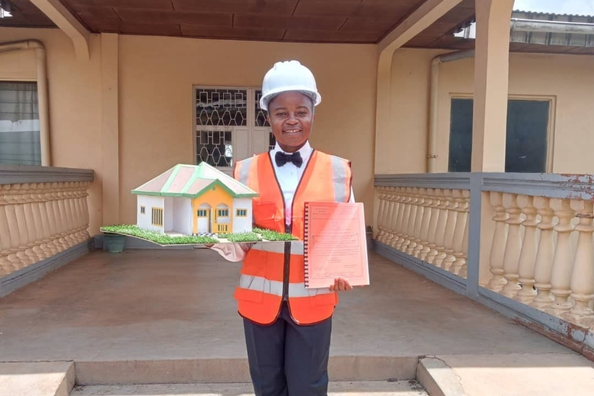 Sr. Wirba Blandine Kinyuy, SSA, holds a model from one of her civil engineering projects, reflecting the technical training she gained with the help of ASEC’s Scholarship Program.