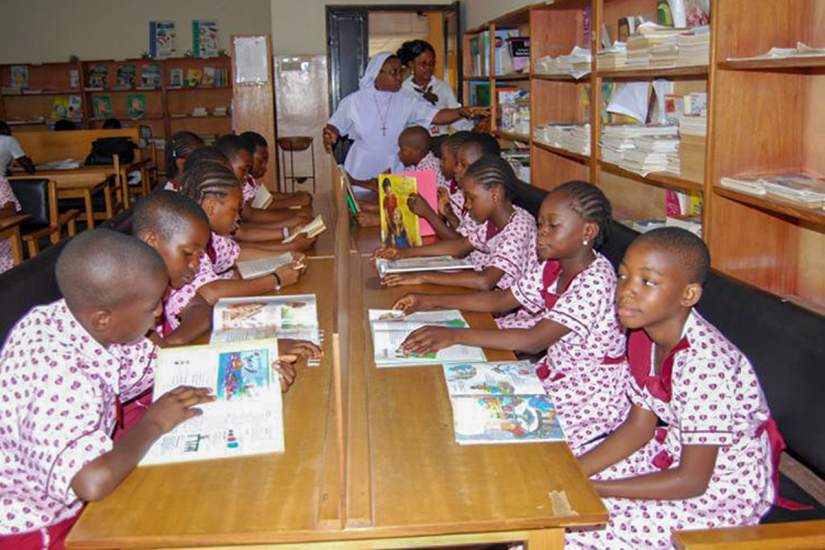 Students of Eucharistic Heart of Jesus Nursery and Primary School reading books in their new library. Funding for the library and books was secured by SLDI alumna Sr. Immaculata Njok, EHJ, who is working to improve literacy and infrastructure in Africa.