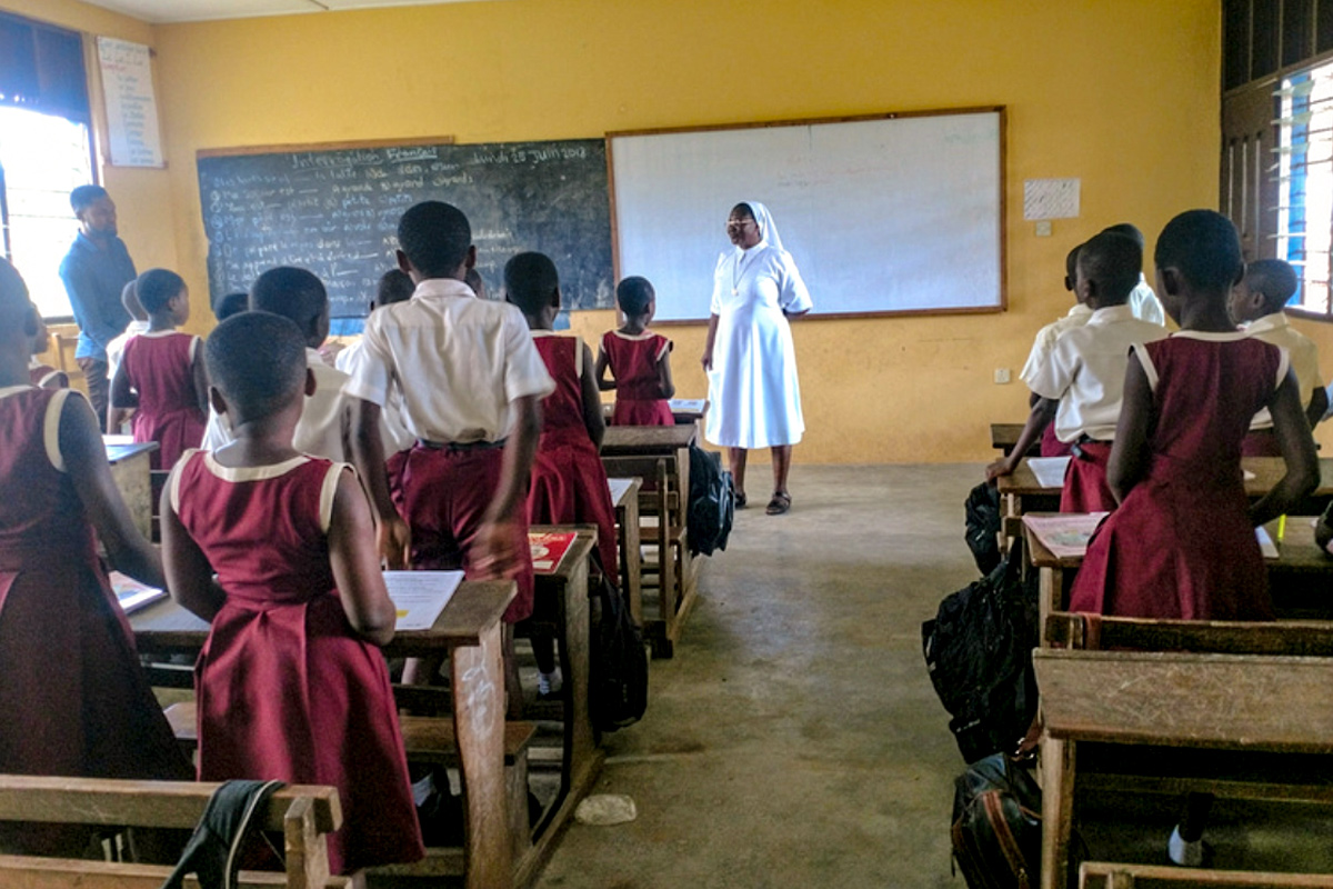 A Society of Jesus (SIJ) sister teaches young students of Infant Jesus Preparatory school in Twifo Praso, Ghana.