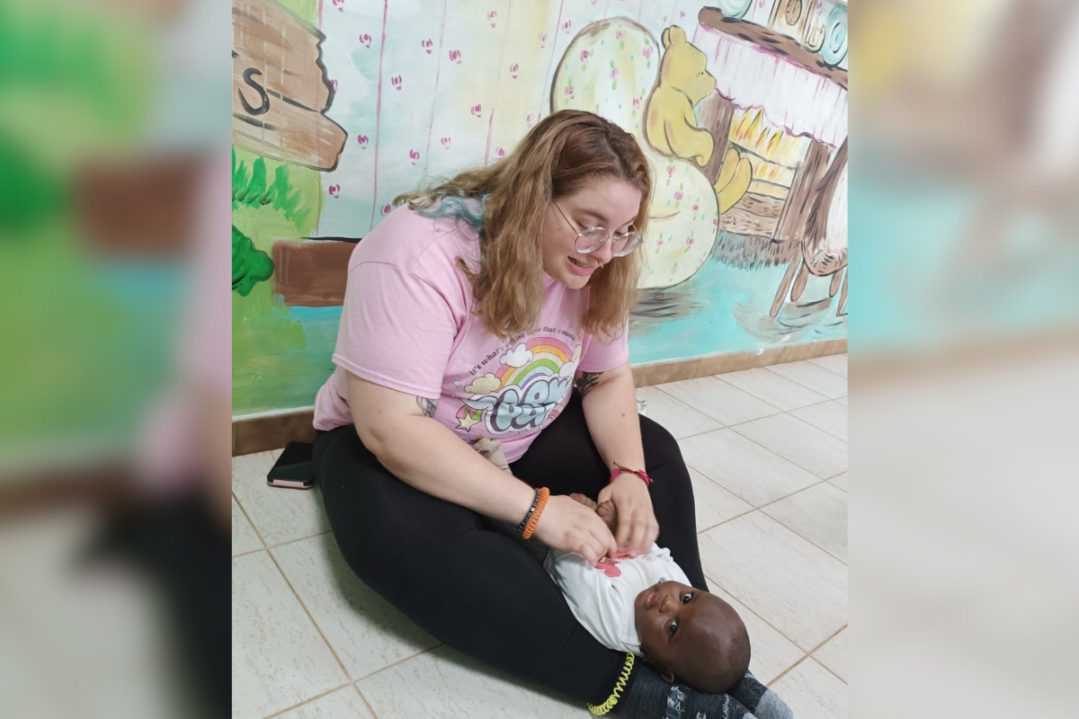 Isabella Schmeltzer, a Chestnut Hill College student, shares a joyful moment with a child during ASEC’s 2024 Service Learning trip to Kenya.