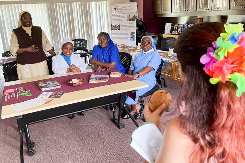 From left to right, Sr. Nancy Kamau, LSOSF, Sr. Lina Wanjiku Ndugn’u, SE; Sr. Clarisse Remjika Jaiwo, SST; and Sr. Francisca Demoah, SIJ, talk to a student at the ASEC headquarters at Marywood University in Scranton, PA.