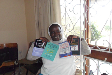 Sr.-Zavero-Beatrice-Karimi-posing-with-her-text-books