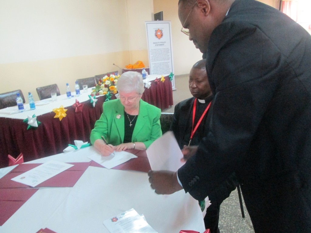 Sr. Anne Munley, IHM, Ph.D. together with Reverend Dr. Pius Rutechura, Vice Chancellor of the Catholic University of Eastern Africa (CUEA), signing the MOU