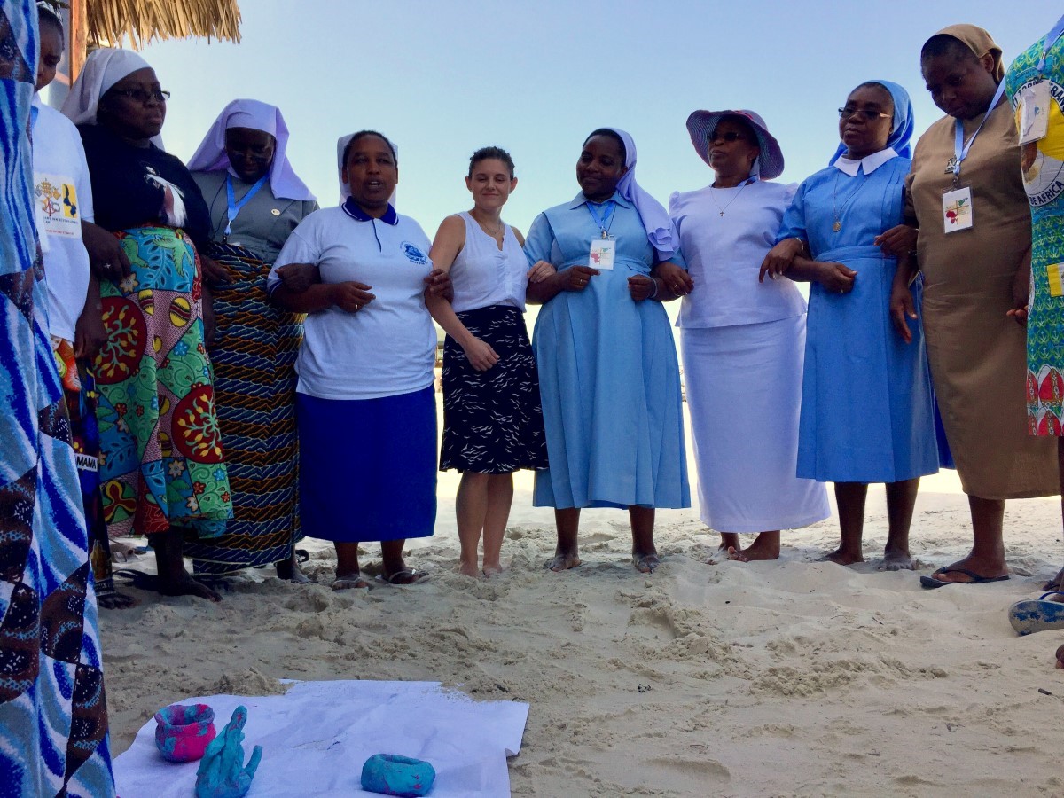 ASEC Staff arm in arm during team building exercises at the Tanzania staff training