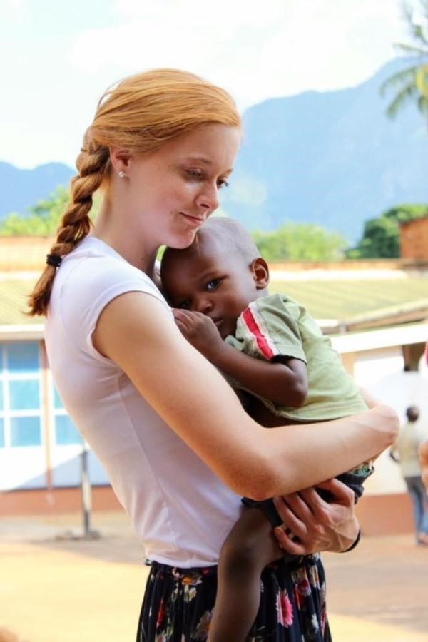Emily  with an orphaned boy in Tanzania